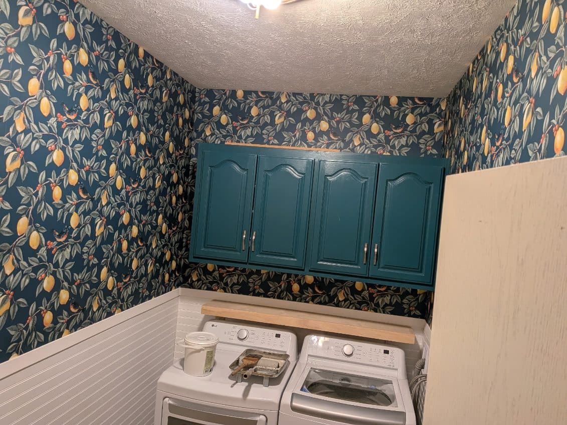 Citrus print wallpaper installed in a laundry room