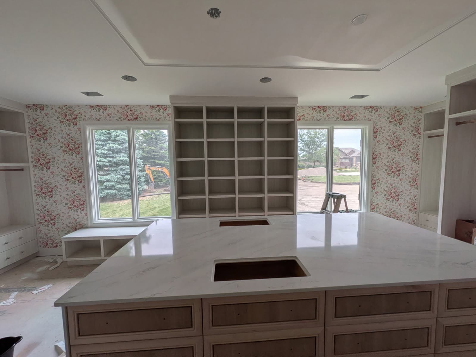 Floral wallpaper surrounding custom built-in shelving